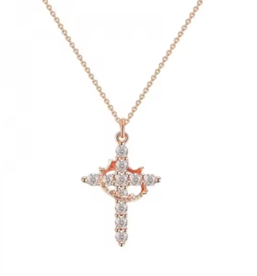 Rose gold cross necklace with diamonds on a white background