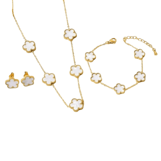 Jewelry set with gold chain necklace, bracelet, and earrings on a white background