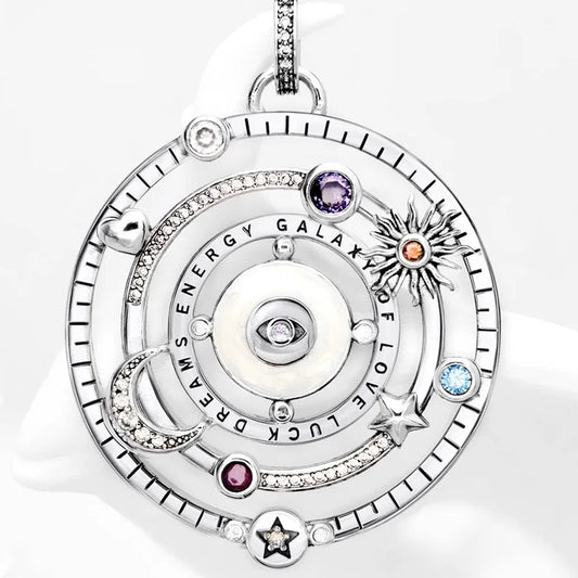 Silver pendant with gemstones on a white background.