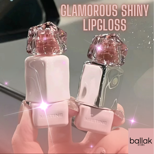 Two tubes of 'Glamorous Shiny Lipgloss' with a sparkling pink glossy finish, held between fingers, with the brand name 'ballak' visible in the image.