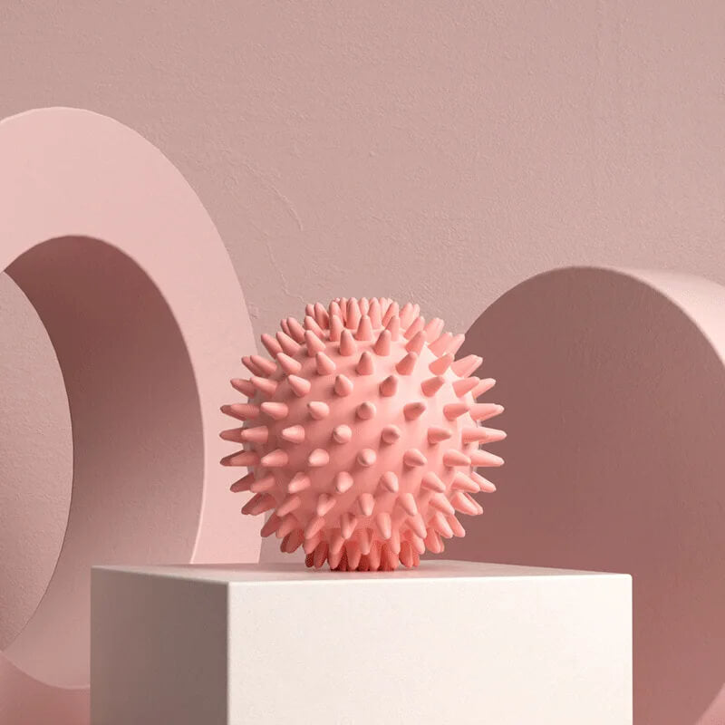 Pink textured ball on a white platform with a pink abstract background