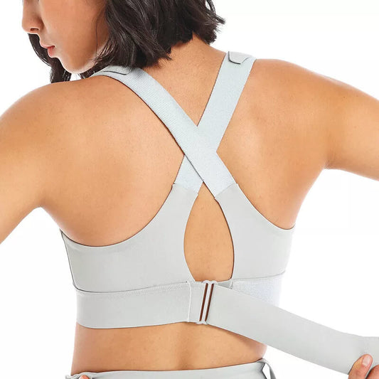 Light gray sports bra worn by a person on a white background