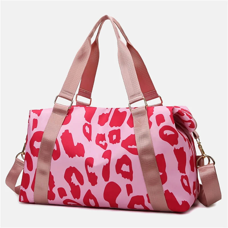 Pink duffel bag with red leopard print pattern on a white background
