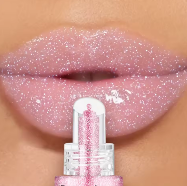 Pink glittery lip gloss being applied to lips with a close-up view.