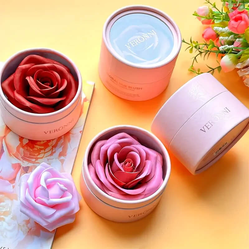Pink and white rose-shaped soaps in containers with 3D Rose Petal Shaped Blush on a yellow background.