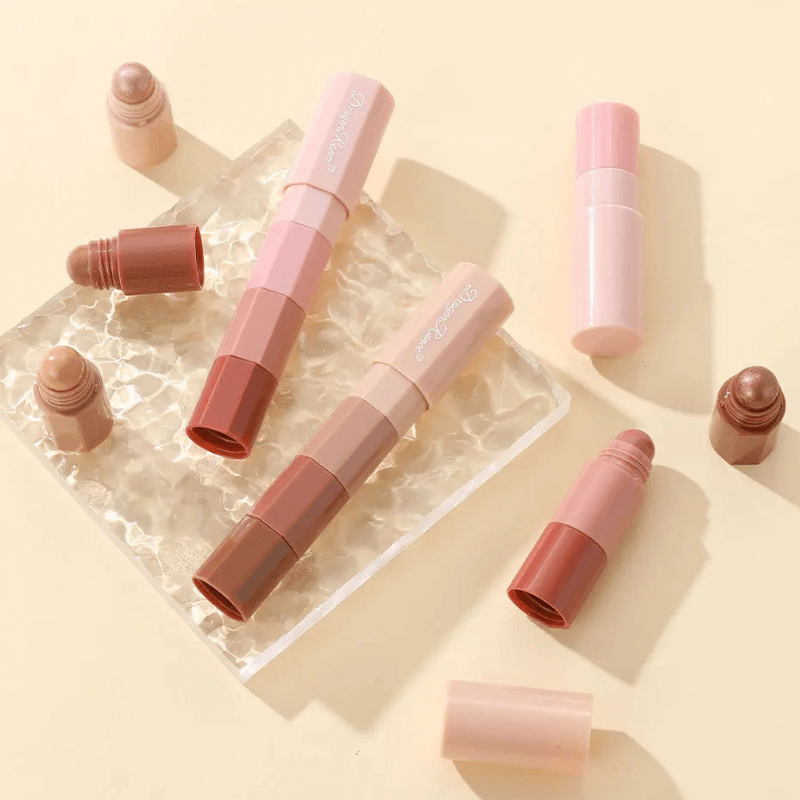 Set of lip products including lipsticks and lip glosses on a light beige background