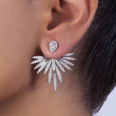 Close-up of a person wearing a sparkling silver earring.