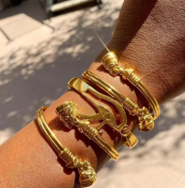 Gold bracelet on a wrist with a blurred background