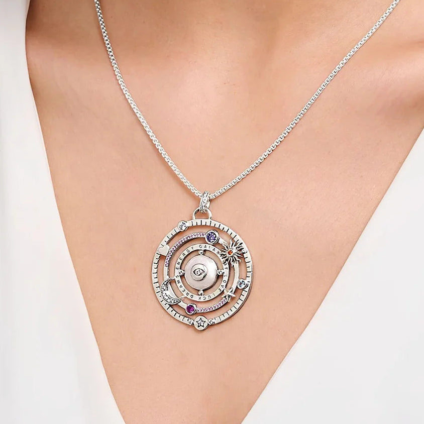 Silver pendant necklace on a person's neck with text indicating chain purchase separately.