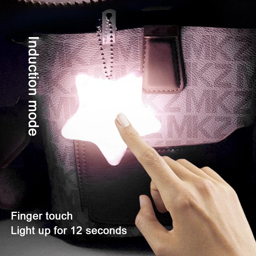 Star-shaped induction light being activated by a finger touch on a pink bag.