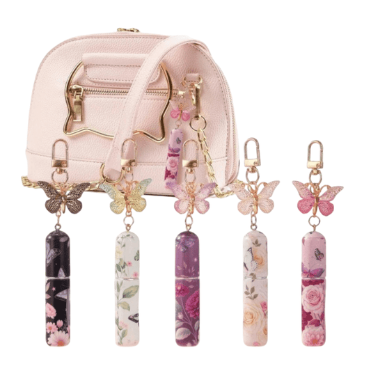 Set of decorative keychains with floral and butterfly designs on a white background