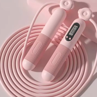 Pink jump rope with digital counter on a light pink background