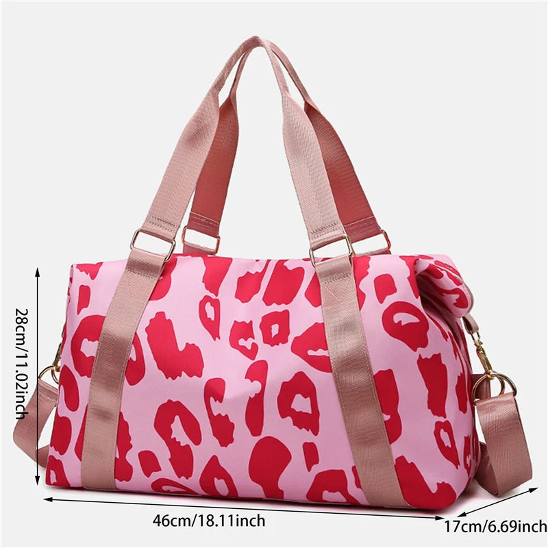 Pink duffel bag with red leopard print and brown straps, shown with measurements on a white background.