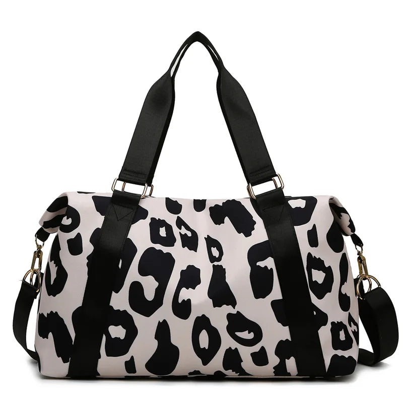 Leopard print duffel bag with black straps on a white background